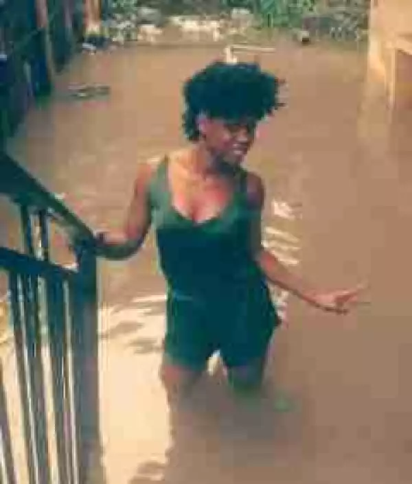 Young Nigerian lady strikes a pose before her flooded home in Yaba (Photos)